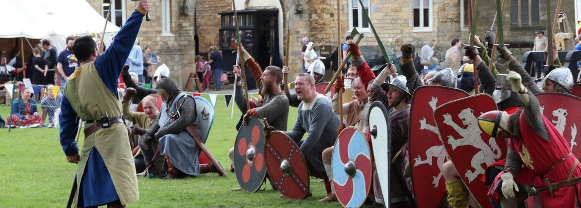 Photograph showing reenactors in medieval costume on the battlefield