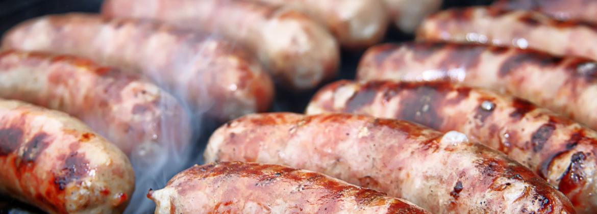 Grilled sausages on an outdoor barbecue