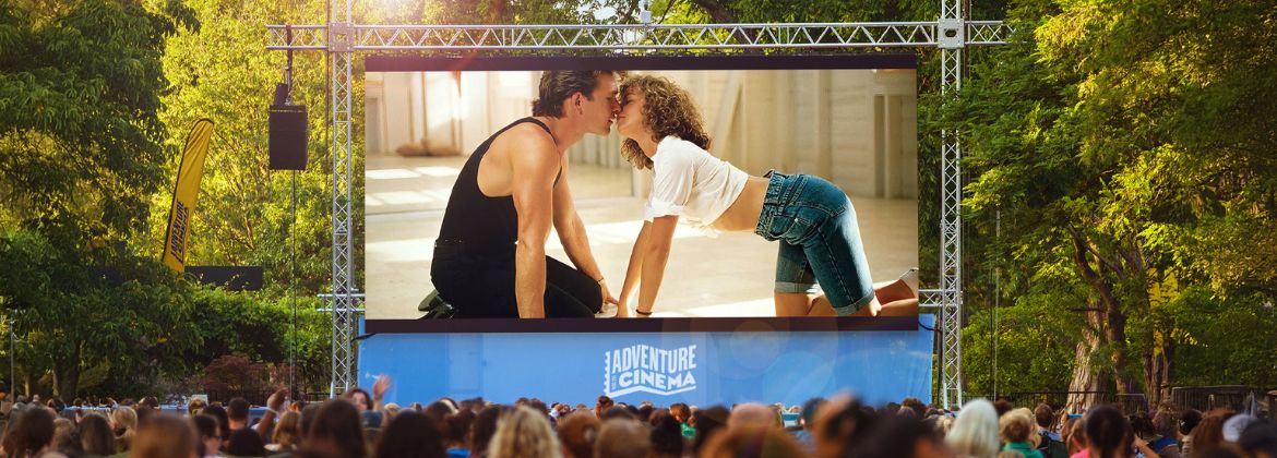A photograph of an outdoor screen showing a clip from the film Dirty Dancing