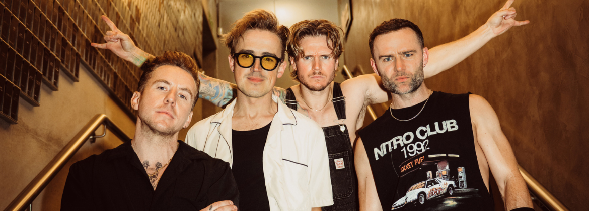 Picture of McFly band members stood looking at the camera