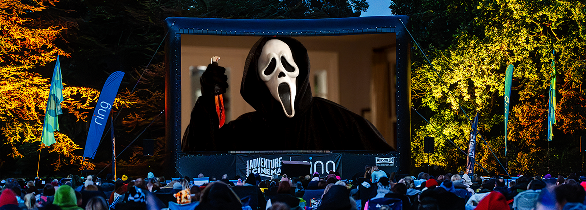 Outdoor cinema screen with the movie Scream playing