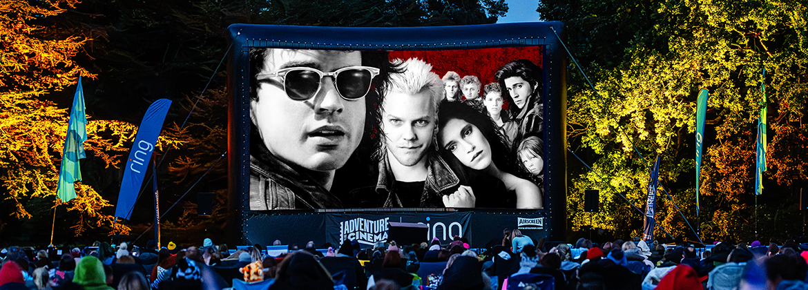 Outdoor cinema screen with the movie The Lost Boys playing