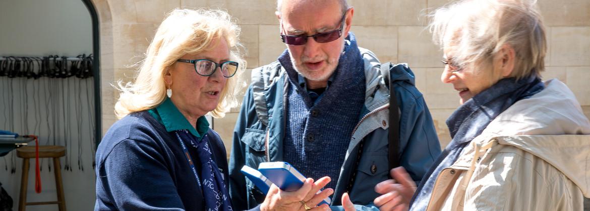 Group of tourists, sharing information on their mobile devices