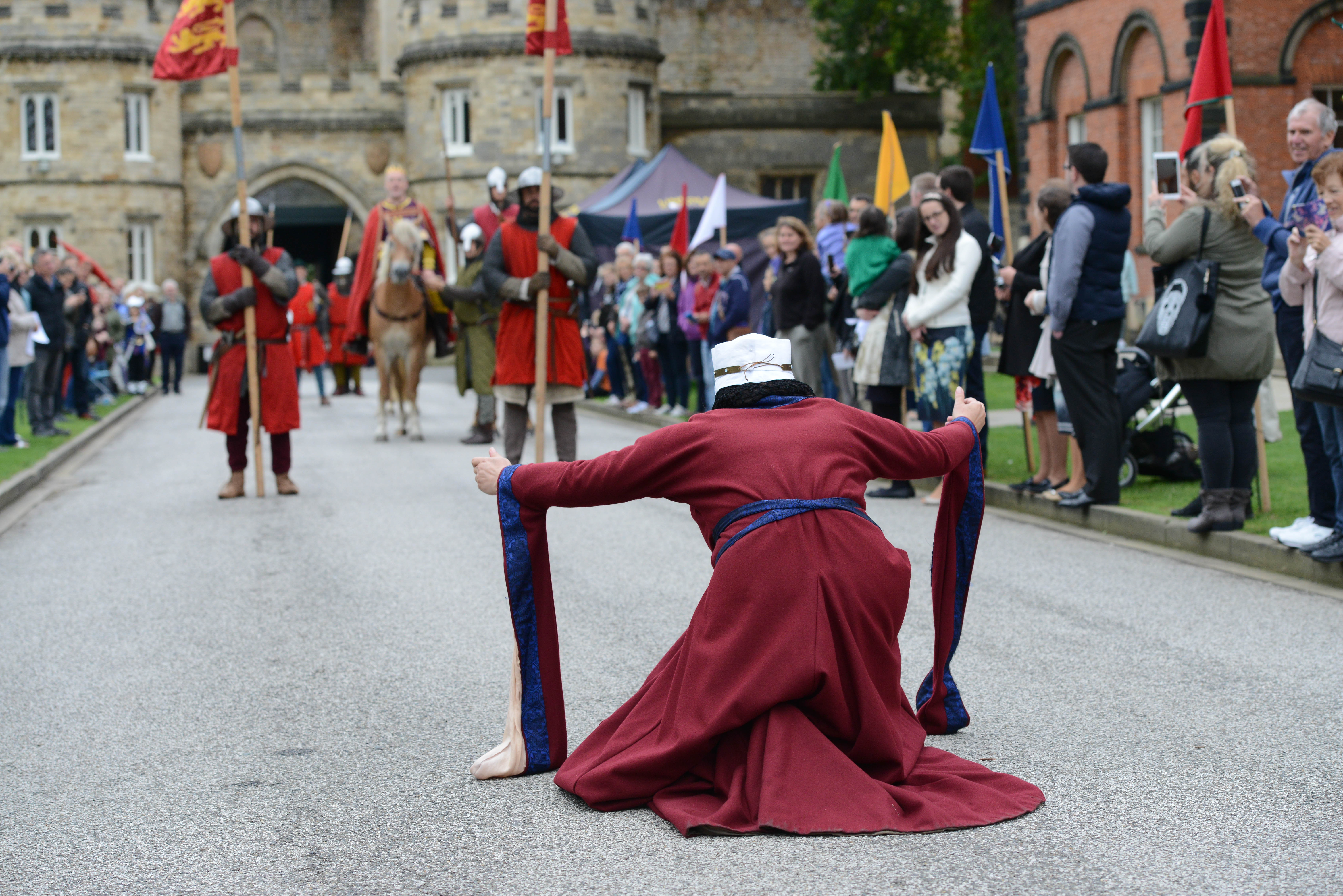 Queen bowing to a medieval king