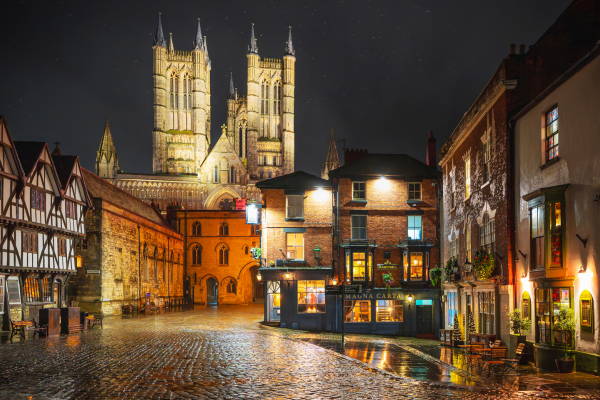 Lincoln's Castle Hill and Cathedral illuminated at night. Photography by Andrew Scott.